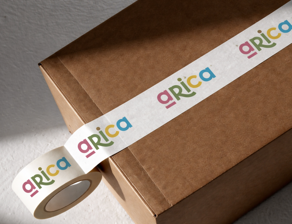 Branded packaging tape with colorful logo applied on a brown shipping box.